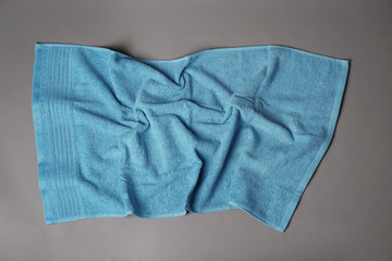 Soft terry towel on grey background, top view