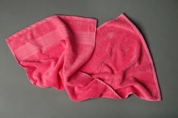 Soft terry towel on grey background, top view