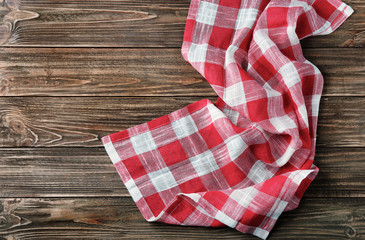 Checkered kitchen towel on wooden table