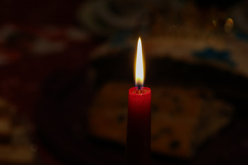 Burning candle on a dark background