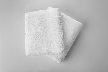 Soft terry towels on light background, top view