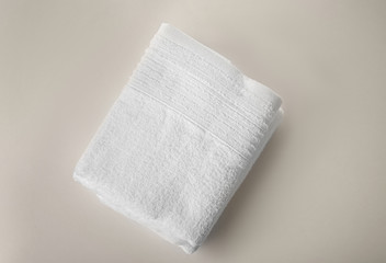 Soft terry towel on light background, top view