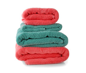Stack of soft terry towels on white background