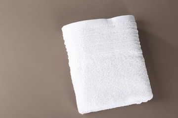 Soft terry towel on color background, top view