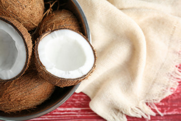 Bowl with fresh coconuts on table
