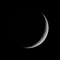 Naklejka premium Moon - Waxing Crescent against black sky background