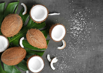 Obraz na płótnie Canvas Composition with green leaf and fresh coconuts on grey background