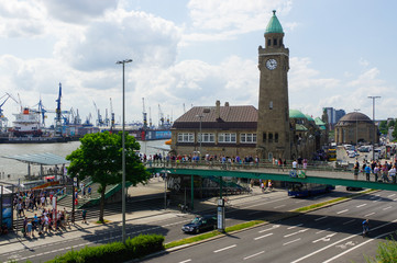 HAMBURG, GERMANY - JULY 18, 2016: Beautiful view of famous Landungsbruecken with commercial harbor...