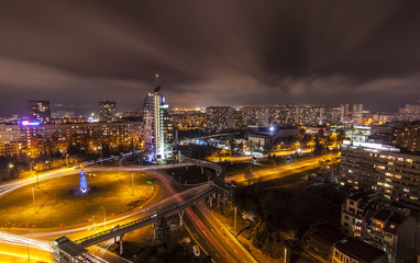 landscape of a night city shot from high. illuminated urban landscape and traces of car lights