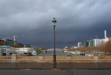 Fototapeta na wymiar Storm clouds on on Bercy bridge in Paris city