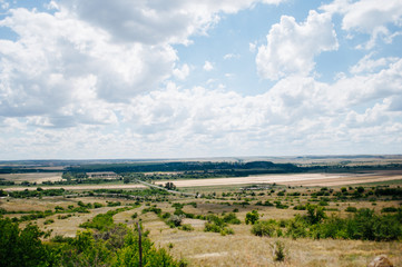Fototapeta na wymiar Landscape with summer steppe and cloudy sky in Donbass region of Ukraine