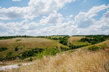 Landscape with summer steppe and cloudy sky in Donbass region of Ukraine