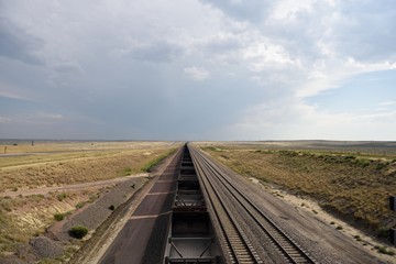 High angle view of an empty coal train passing through a rural landscape in the Powder River Basin in Wyoming 