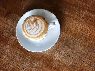 hot coffee in white cup on wooden table top view