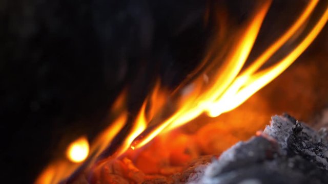 Flames and ash and burning wood in Sami tent close up