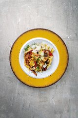 Traditional Italian pappardelle di pomodoro with mushrooms and parmesan as close-up on a plate