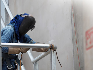 Welding work ,worker with protective welding metal on construction