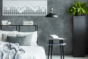 Grey bedroom with black lamp