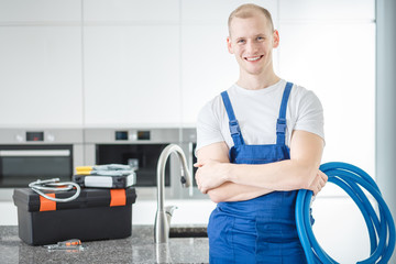 Smiling plumber with blue pipes