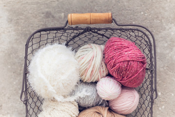 coil wool, yarn, metal basket, concrete background
