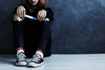 Teenager with pregnancy test - obrazy, fototapety, plakaty