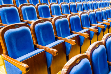 Fototapeta premium Blue brown wooden chairs in the auditorium. Without people.