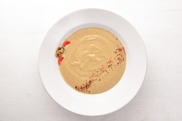 Mushroom puree soup. On a wooden background. Free space for your text. Top view.