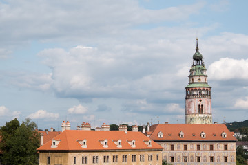 View of the charming medieval town, Cesky Krumlov, from the castle. Beautiful Renaissance Castle Tower, room for copy space. Blue skies with puffy clouds, overcast day.