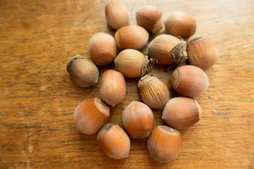 Macro of ripe hazelnuts on wooden table