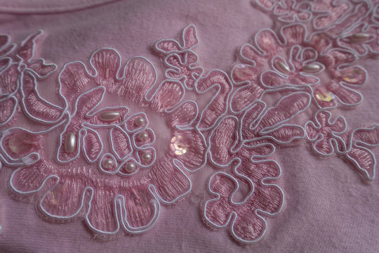 Embroidered pink fabric with sequins and pearls