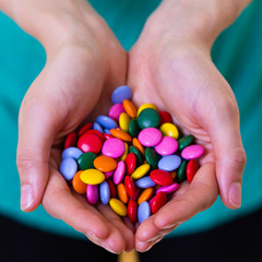 close up of a woman holding candy in her hands