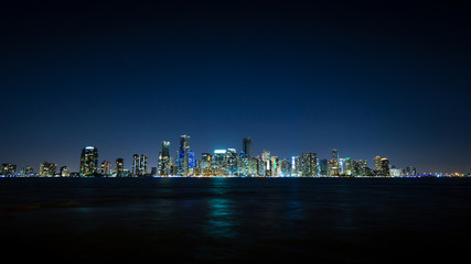 USA, Florida, Miami City Skyline at night with waterfront and reflections