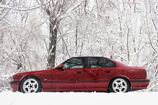 A Beautiful Red Car In A Winter Forest. Cold. Frost.