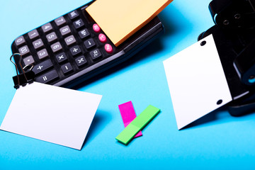 Business card with empty space and binder near sticky notes.