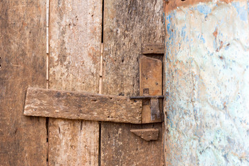 An old wooden door with a little bar lock