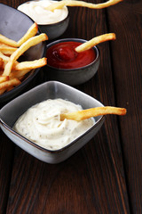 Red and white french fries chips with ketchup and mayonnaise