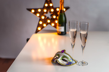Champagne in glasses and a carnival mask