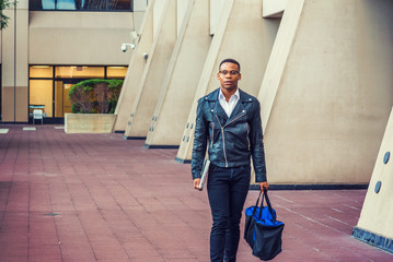 Man Urban Casual Fashion. Wearing black leather jacket, jeans, leather shoes, glasses, holding...