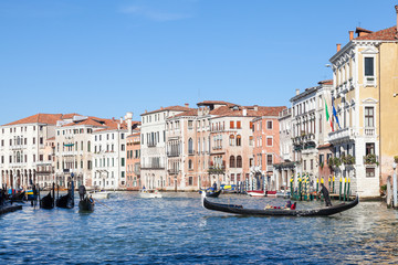 Fototapeta na wymiar Gondola with tourists on the Grand Canal in Cannaregio, Venice, Italy rowing towards Rialto Mercato 