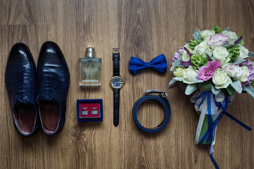 different accessories of a businessman for creating a style of a people lie on a wooden background