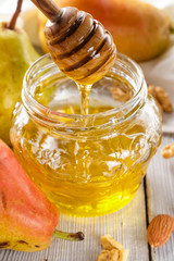 Fototapeta na wymiar Honey, pears, walnuts and almonds