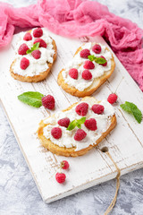 Breakfast slice of bread with Ricotta cheese served with raspberries