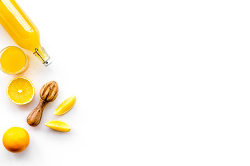 Freshly squeezed orange juice. Juicer and slices of oranges on white background top view copyspace