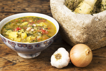 Bowl of pistou soup on an old wooden table