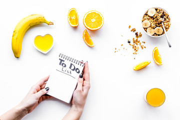 Morning habits of successful people. Healthy breakfast porridge with fruits and planning the day. White background top view