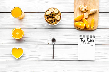 Fototapeta na wymiar Start the day the right way. Healthy breakfast oatmeal with fruits and planning the day. White wooden background top view pattern