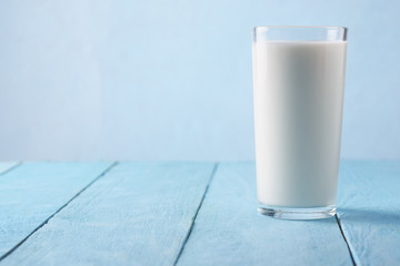 Milk in a glass on a blue background