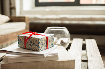  wrapped gift prepared and left on a modern wooden table as a surprise