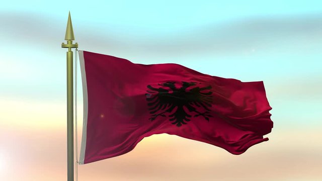 National Flag of the Albania waving in the wind against the sunset sky background slow motion Seamless Loop Animation