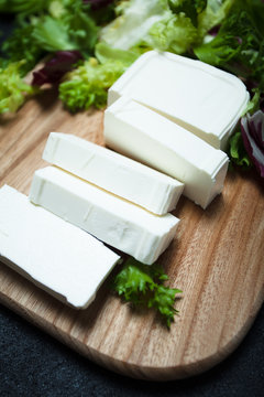 Natural feta cheese from cow's milk sliced with slices.